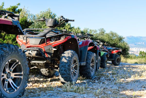Parked ATVs and UTVs on mountain trail